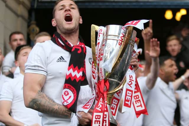 Sheffield Uniteds captain Billy Sharp yells with delight as he shows off the League One trophy last night (Picture: Richard Sellers/PA Wire).