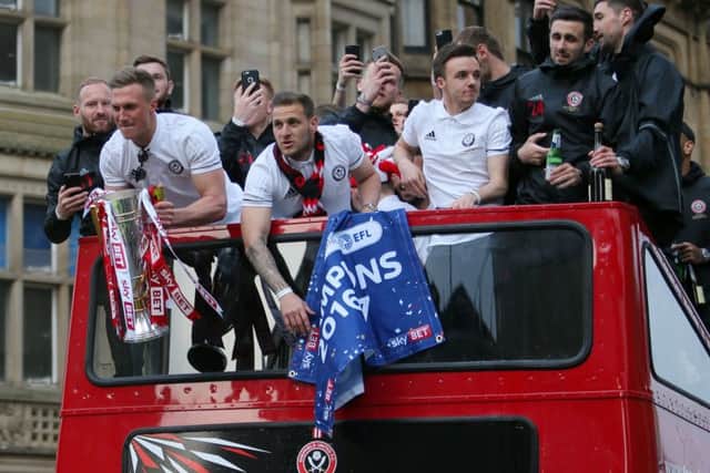 Sheffield United players arrive on an open-top bus during the promotion celebrations