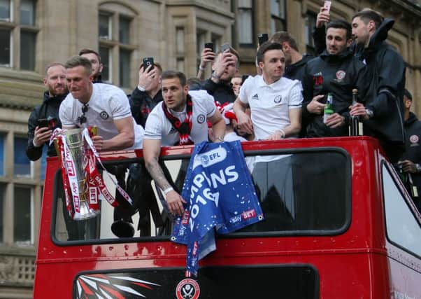 Sheffield United players arrive on an open-top bus during the promotion celebrations