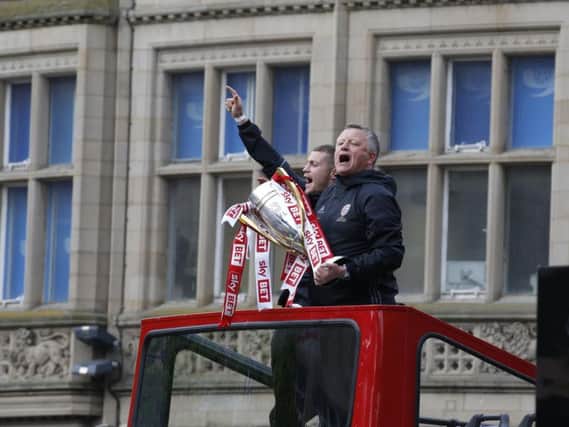 Chris Wilder with the Sky Bet League One trophy on the bus parade in Sheffield