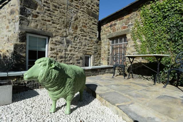 The life-size sheep has been painted in Farrow and Ball