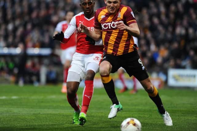 Charlie Wyke muscles out his marker for Bradford during the play-off semi-final