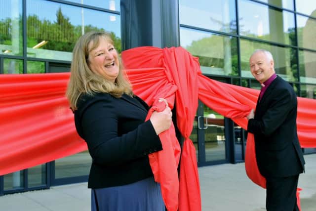 Heather Parry, managing director of the Yorkshire Event Centre, pulls a red ribbon with the Bishop of Leeds, Rev Nick Baines, to officially open the new exhibition hall last year.