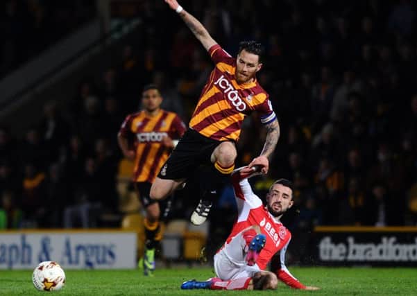Bradford's Romain Vincelot is tackled by Fleetwood's Connor McLaughlin in the first leg (
Picture: Jonathan Gawthorpe)
