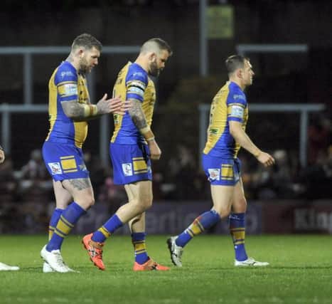 Brett Delaney, Adam Cuthbertson and Danny McGuire leave the field after the defeat to Huddersfield.
