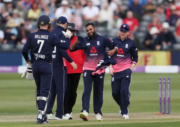 GOOD DAY: Englands Adil Rashid is congratulated by team-mates after taking five wickets against Ireland.