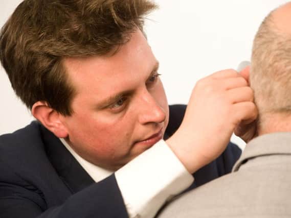 An audiologist conducting a hearing examination at the Tinnitus Clinic