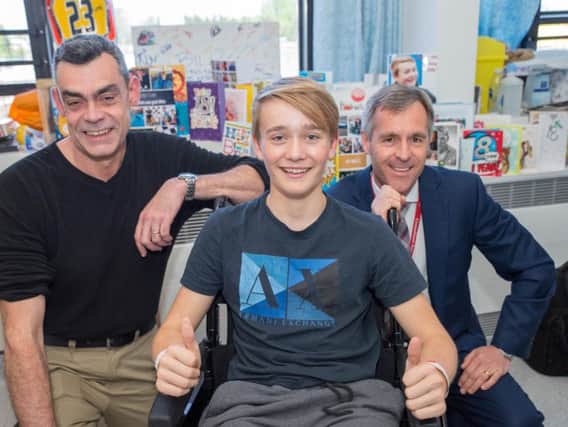Consultant Orthopedic Surgeons Tony Westbrook (right) and Colonel Tom Rowlands (left) with 18-year-old Billy Monger, a teenage British racing driver who has vowed to get back behind the wheel after losing both of his legs following a horror crash.