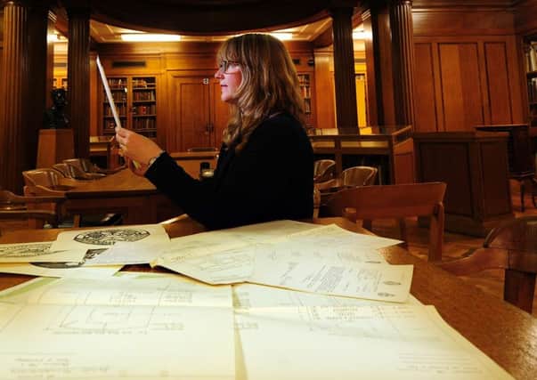 Prof Alison Fell looks at Commonwealth War Grave Commission documents in the Brotherton Library, at Leeds University. (Simon Hulme).