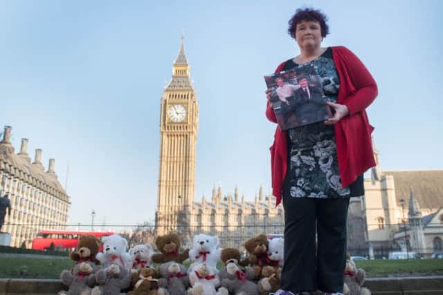Claire Throssell, whose children were killed by her abusive ex-husband in 2014, lays 20 teddy bears in Westminster symbolising the children who have died as a result of unsafe child contact with a parent who is a perpetrator of domestic abuse, after she delivered a petition to Downing Street. Photo: Stefan Rousseau/PA Wire