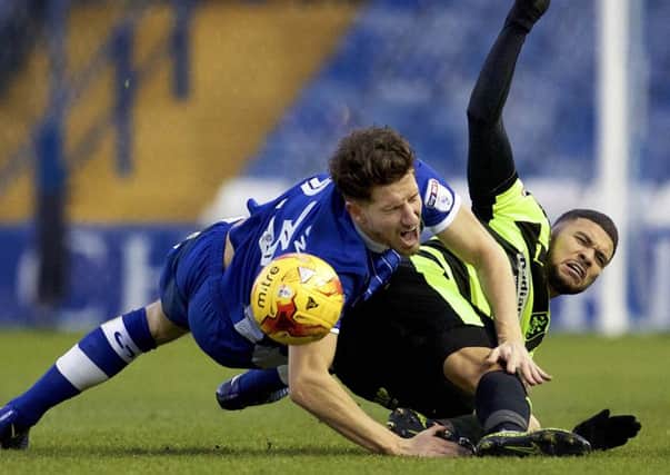 Sheffield Wednesday's Sam Hutchinson feels a challenge from Town's Nahki Wells when the two sides met earlier this season.(Picture: Steve Ellis)