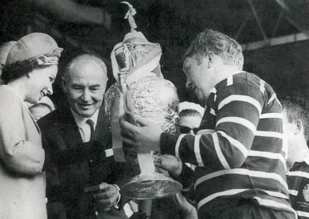 featherstone, captain Malcolm Dixon collects the Challenge Cup from the Queen after victory in the 1967 League Cup final.