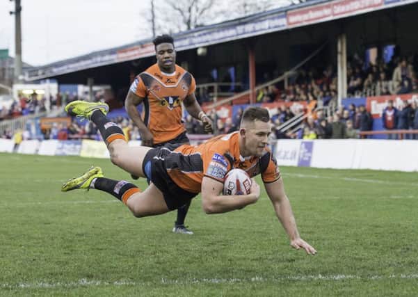 WINGING IT: Castleford Tigers' Greg Eden dives over for a try against Wakefield Trinity.