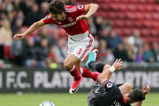 Middlesbrough's George Friend is challenged by Southampton's Shane Long . Picture: Richard Sellers/PA