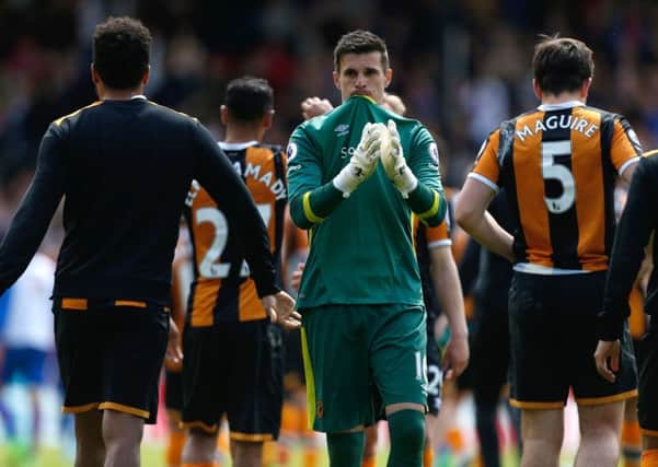 Down and out: Eldin Jakupovic applauds the travelling Hull City fans who could only watch in frustration as their team were relegated.