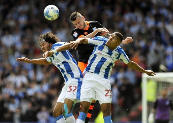 Sheffield Wednesday's Daniel Pudil defies the odds to beat Collin Quaner and Izzy Brown to the ball (Picture: Steve Ellis).