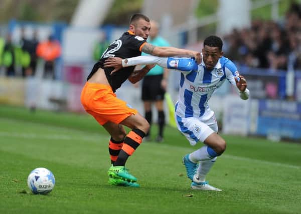 CATCH ME IF YOU CAN: Huddersfield Town's Rajiv Van La Parra tries to give  Sheffield Wednesday's Jack Hunt the slip. Picture: Tony Johnson.