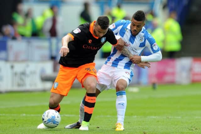 Huddersfield's Elias Kachunga grapples with Wednesday's Daniel Pudil in the first leg. (Picture: Tony Johnson)