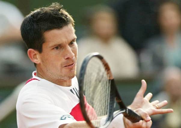 Tim Henman of Britain returns the ball to Juan Ignacio Chela of Argentina during their French Open quarter-final match at Roland Garros in  June 2004. Picture: AP/Michel Euler