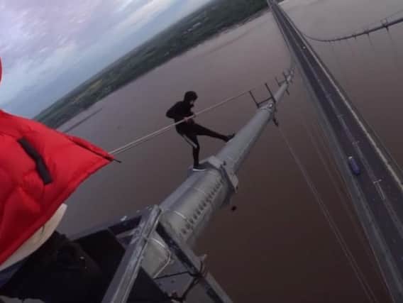 Thrill-seekers scaling the Humber Bridge