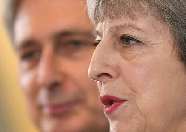 Theresa May and Philip Hammond at a pre-manifesto press conference overshadowed by reports of splits between the Prime Minister and Chancellor.