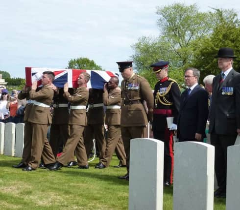 The bearer party from the Yorkshire Regiment carrying the coffin of PrivateHenry Parker in view of senior dignitaries.