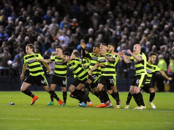 The Huddersfield Town players celebrate after Danny Ward saves Fernando Forestieri's penalty
