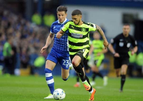Huddersfield Town's Nahki Wells gets away from Sheffield Wednesday's Sam Hutchinson. Picture: Tony Johnson.