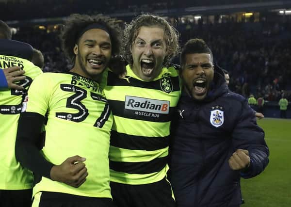 Huddersfield Town's Isaiah Brown, Michael Hefele and Elias Kachunga celebrate the win over Sheffield Wednesday