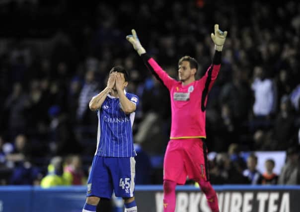 Fernando Forestieri shows his dismay after missing the final penalty while Huddersfield Town goalkeeper Danny Ward begins his celebrations. Picture: Steve Ellis