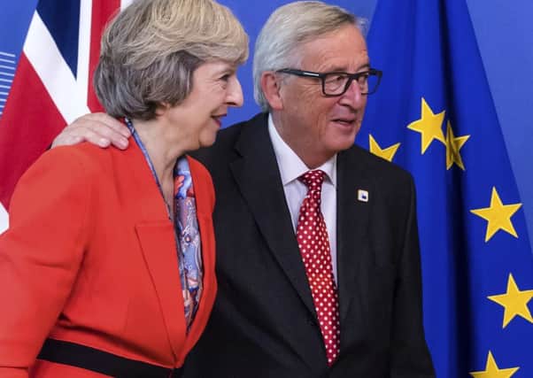 Theresa May with European Commission president Jean-Claude Juncker.