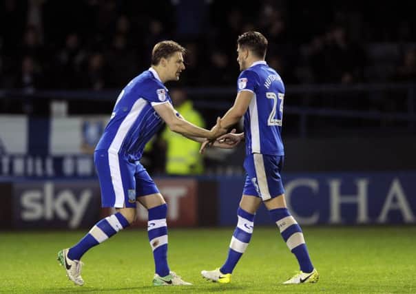 Sam Hutchinson consoled by skipper Glenn Loovens after missing a penalty against Huddersfield. Picture: Steve Ellis