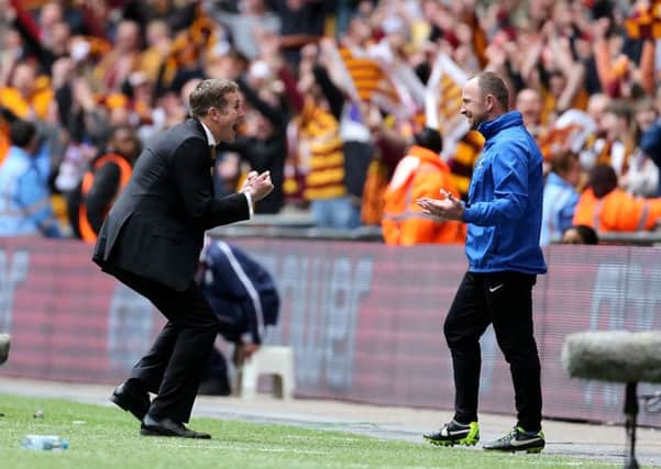 Phil Parkinson celebrates with assistant boss Steve Parkin after seeing Bradford City promoted in the League Two play-off final against Northampton in 2013 (Picture: PA).