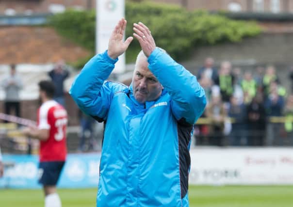 York manager Gary Mills applauds the fans at the final whistle.