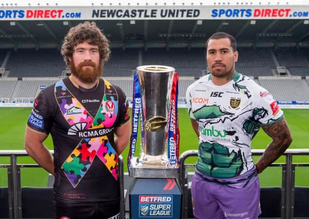 St Helens's Kyle Amor & Hull FC's Fetuli Talanoa with the Betfred Super League trophy ahead of their Magic Weekend game.
