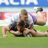 St Helens' Tommy Makinson scores a try under pressure from Hull FC's Chris Green (Photo: PA)