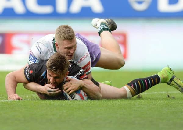St Helens' Tommy Makinson scores a try under pressure from Hull FC's Chris Green (Photo: PA)