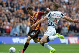 Millwall's Shaun Hutchinson swoops in on Bradford's  Billy Clarke as he lines up a shot at Wembley on Saturday.  Picture: Bruce Rollinson