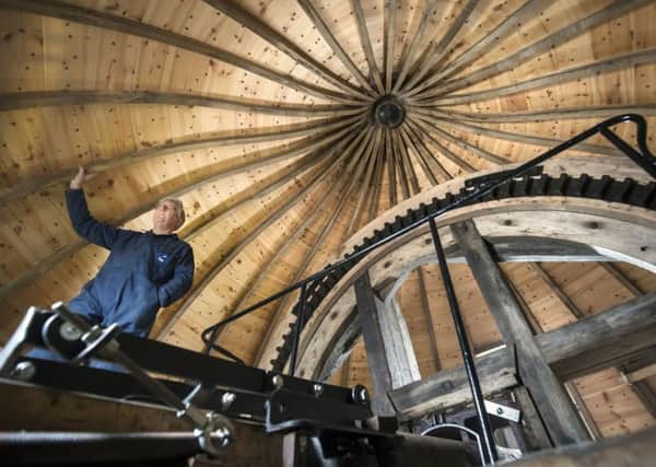 FLOUR POWER: Holgate Windmill Preservation Society founding trustee Stephen Potts inside the windmill; flour produced by the mill and the Bake Off team. PIC: PA