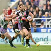St Helens' Tommy Makinson beats the challenge of Hull FC's Danny Houghton. Picture: Anna Gowthorpe/PA