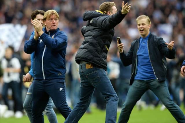 Stuart McCall is surrounded by Millwall fans during the pitch invasion at Wembley on Saturday.  Picture: Bruce Rollinson