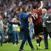 Alex Jones is taunted by a Millwall fan nduring the pitch invasion at Wembley on Saturday.  Picture: Bruce Rollinson