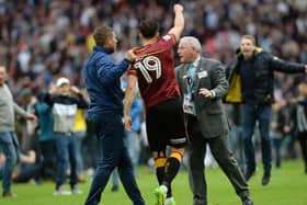 Alex Jones is taunted by a Millwall fan nduring the pitch invasion at Wembley on Saturday.  Picture: Bruce Rollinson