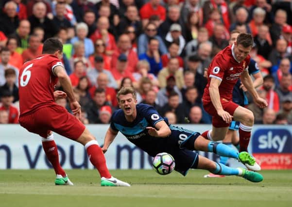 Middlesbrough's Patrick Bamford battles for the ball with Liverpool's James Milner (right) and Dejan Lovren.