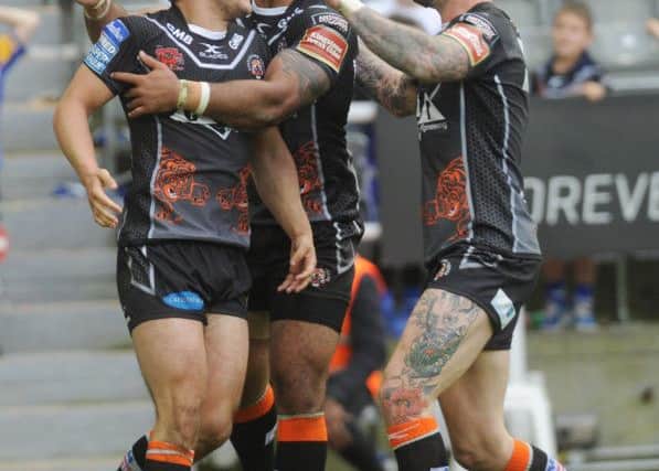Castleford Tigers' players celebrate Tom Holmes's try. Picture: Steve Riding.