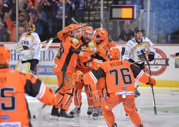 MAGICAL MOMENT: Guillaume Desbiens is mobbed by his team-mates after scoring the overtime winner against Nottingham Panthers in the 2017 Elite League play-off quarter-final. Picture: Dean Woolley.
