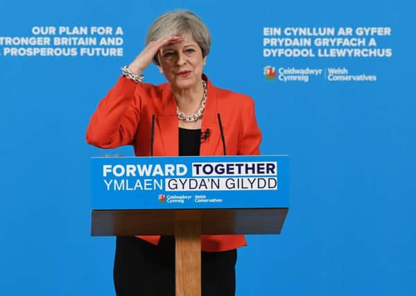 Theresa May came under fire over social care during the launch of her Welsh manifesto.