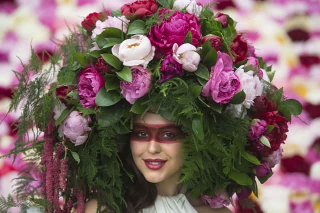 A model wears a bespoke Peony Floral headdress on the Primrose Hall stand during the press preview of the RHS Chelsea Flower Show