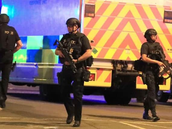 Armed police at the Manchester Arena after last night's explosion