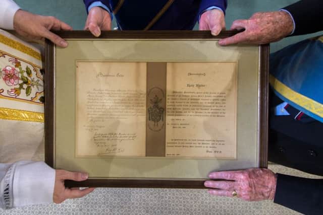 Date: 17th May 2017.
Picture James Hardisty.
A handwritten blessing for a Yorkshire church sent by Pope Pius X in 1908 has been uncovered in an attic after being lost for 60 years and has been presented back to the parish priest at St Austin's Church, Wentworth Terrace, Wakefield. Pictured Norman Hazell, President of the Catholic Young Mens Society, Michael Timlin, Secretary of the Catholic Young Mens Society and Monsignor David Smith, holding the discovered letter.